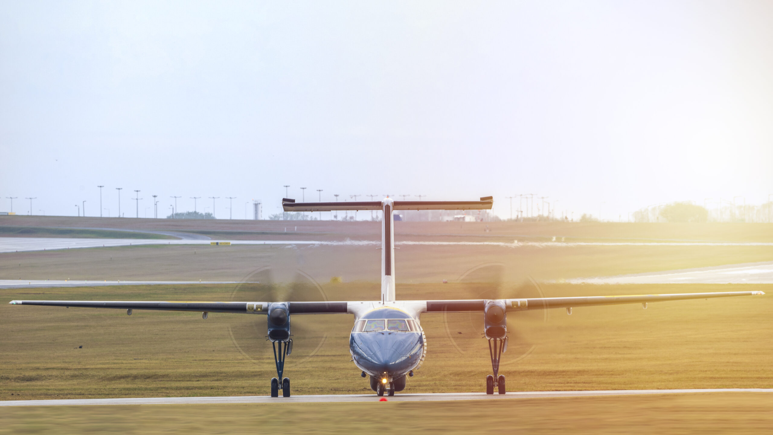rear-view-airplane-airport-runway-against-sky